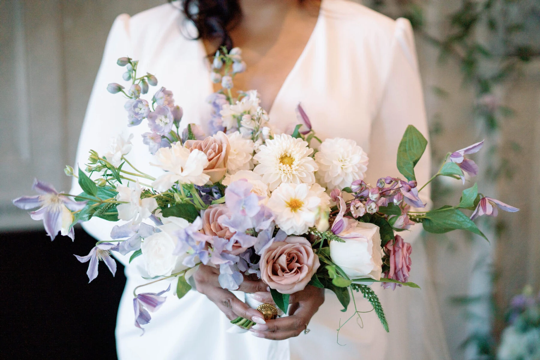 Elopement Wedding: A bridal bouquet of white dahlias, mauve roses, and purple clematis and sweet peas.