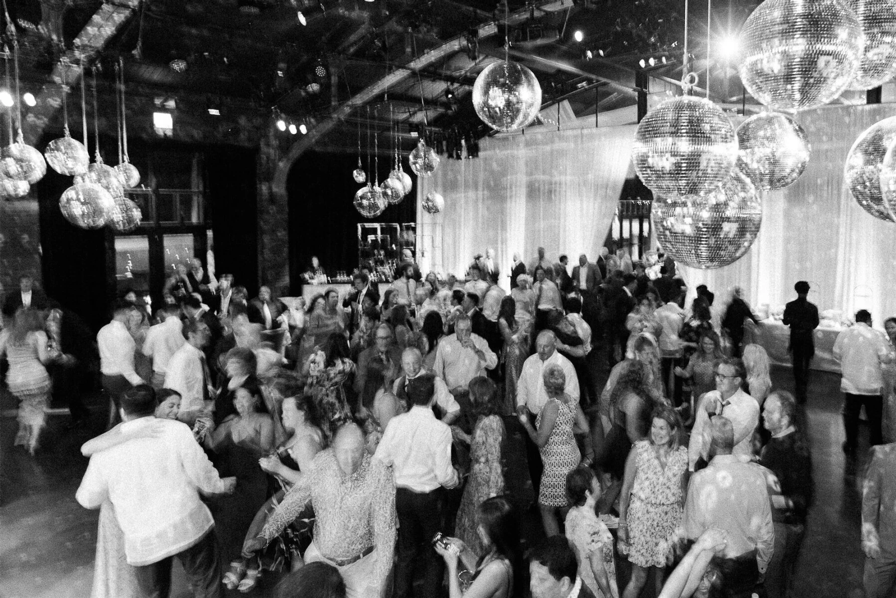 Under an installation of disco balls, guests packed the dance floor at an enchanted waterfront wedding.