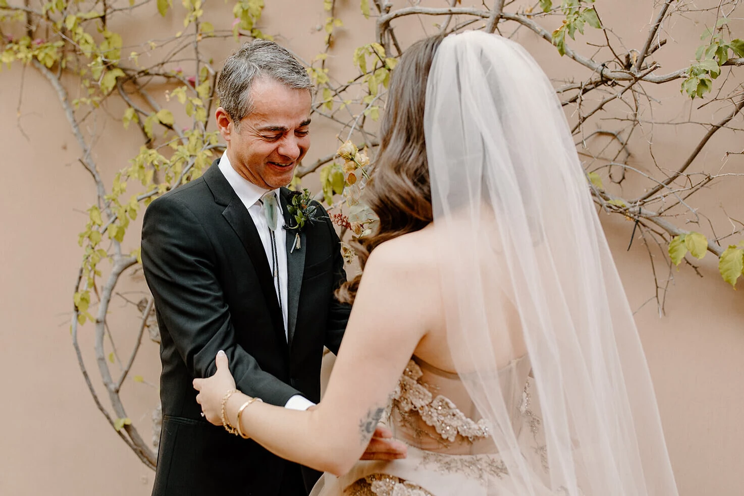 First Look Photos: A dad embracing his daughter on her wedding day.