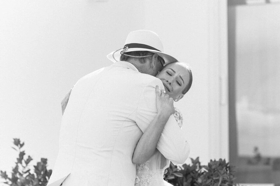 First Look Photos: A bride hugs her father on her wedding day.