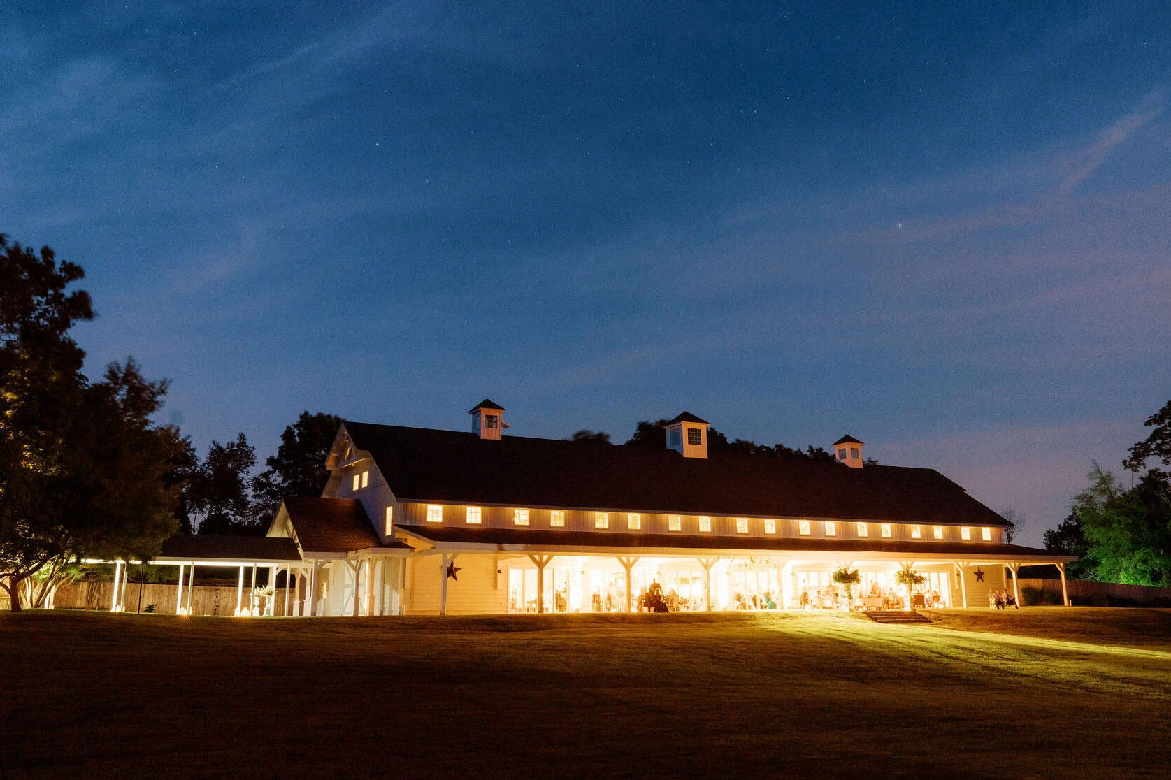 The reception barn was all aglow as the sun set during a Glenmere Mansion wedding.