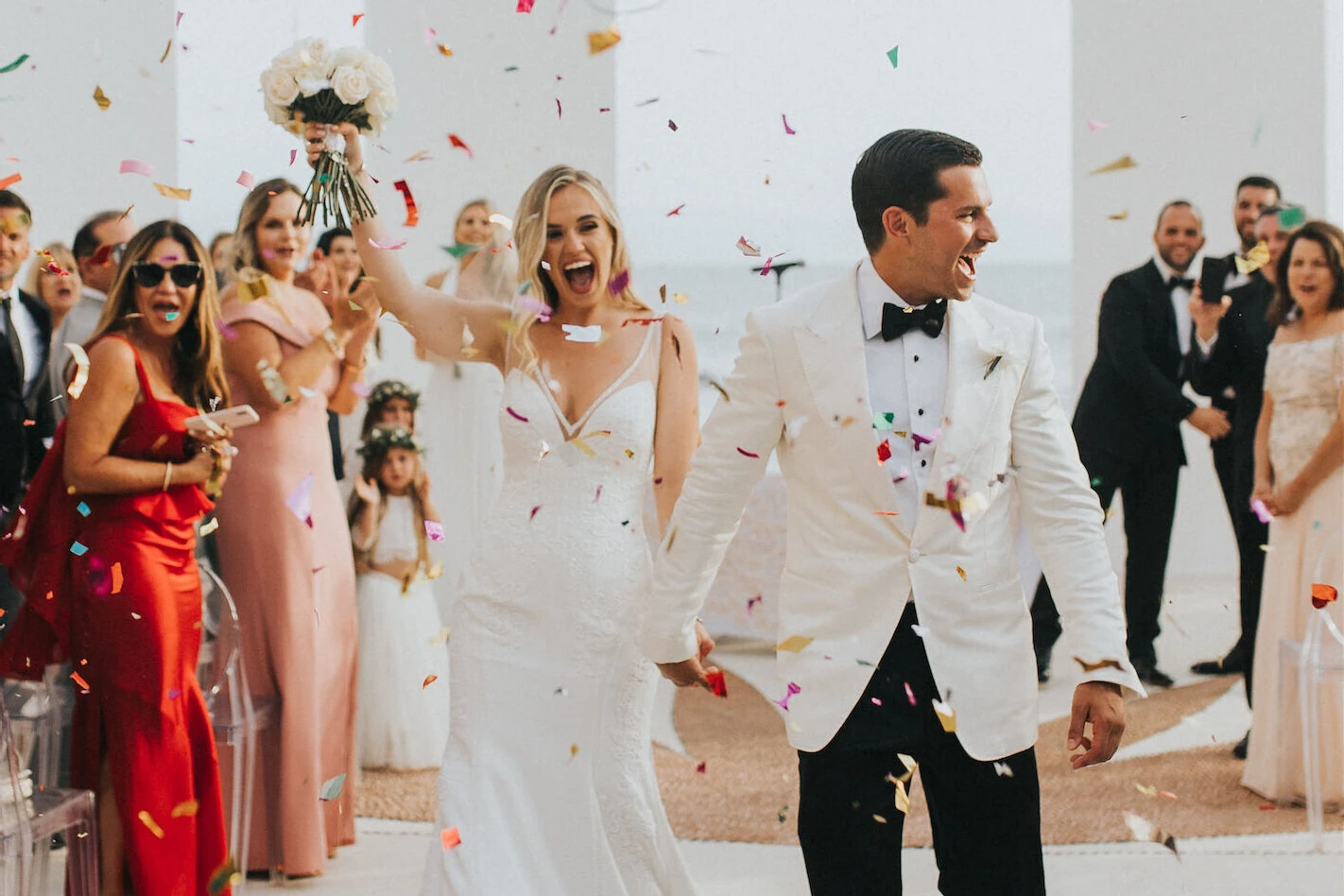 Grand Velas Riviera Nayarit: A bride and groom being showered with confetti after exchanging vows at their wedding.