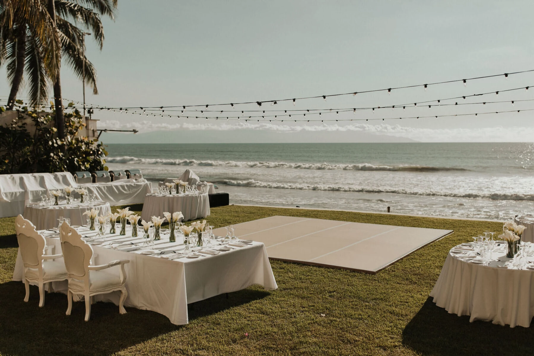 Grand Velas Riviera Nayarit: A waterfront reception area featuring a sweetheart table overlooking the dance floor and ocean.