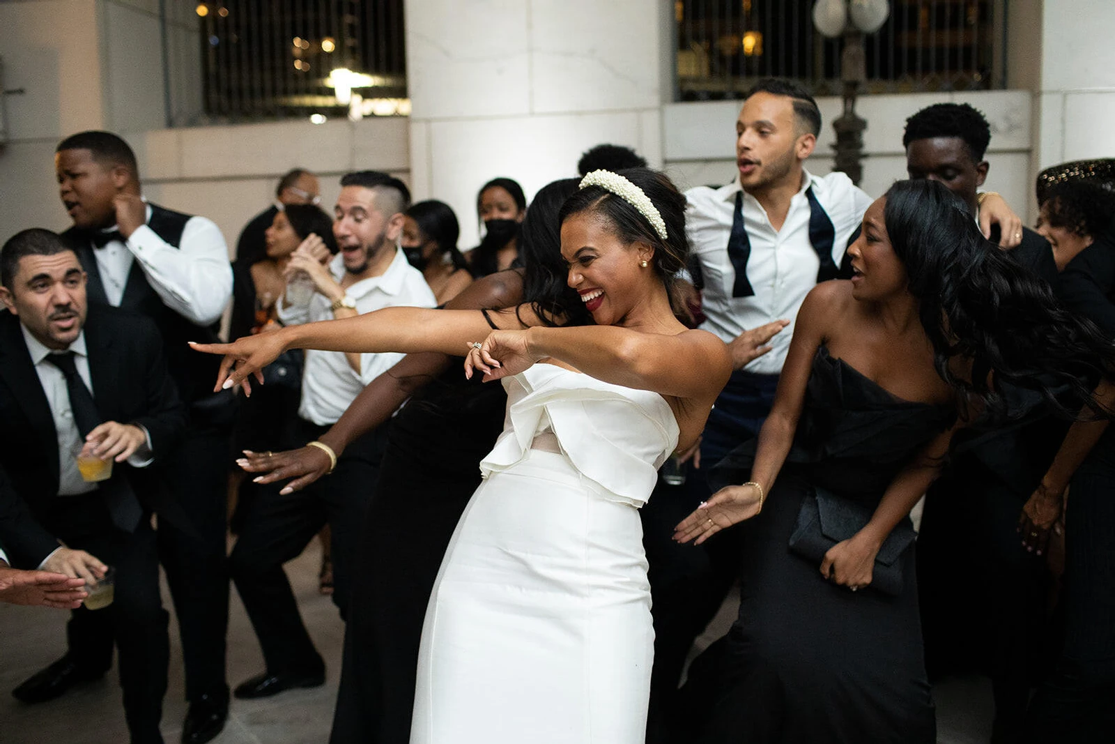 Holiday Wedding: A bride smiling, pointing, and dancing with friends.