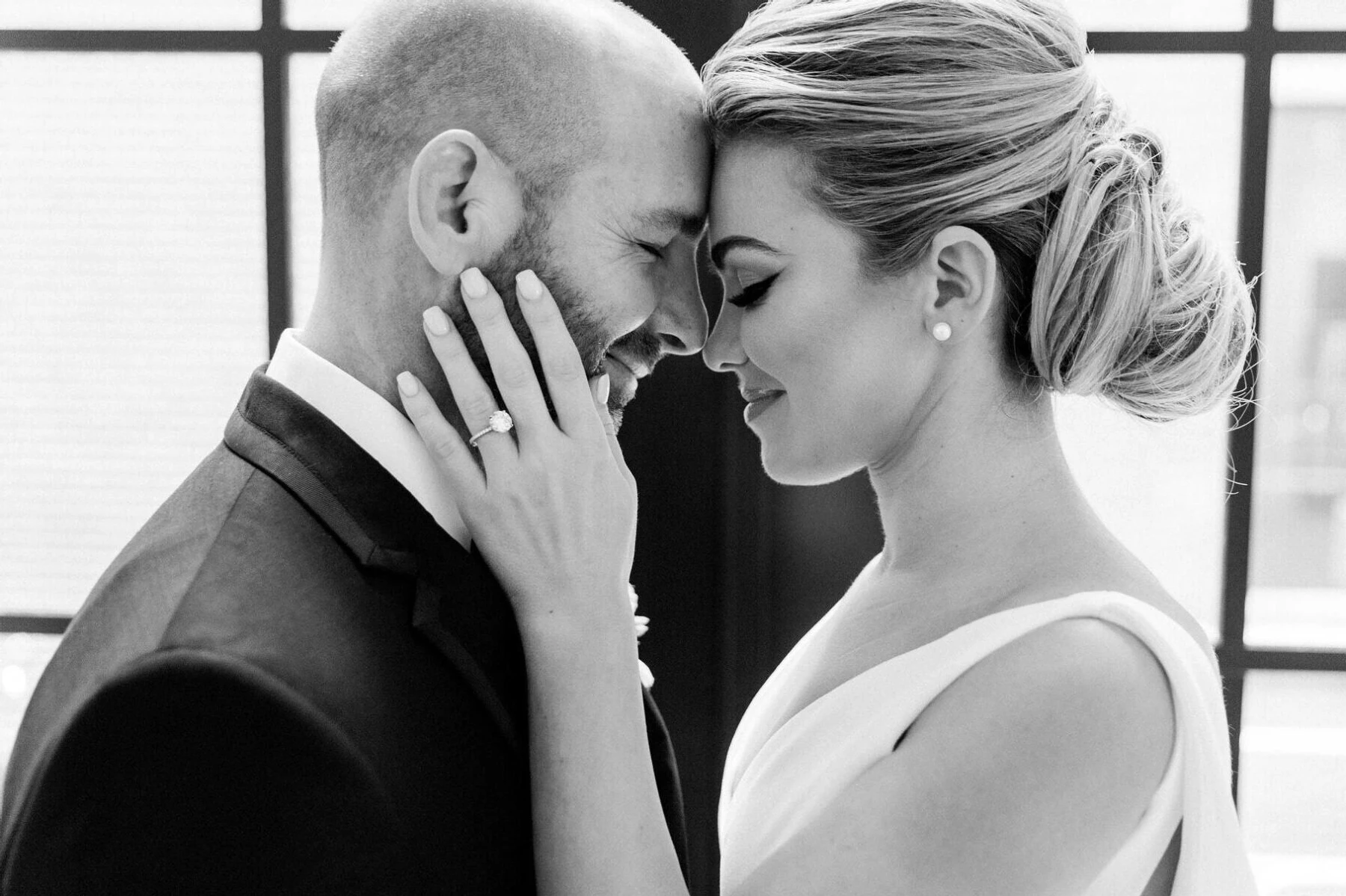 A candid moment between a groom and bride at their industrial wedding.