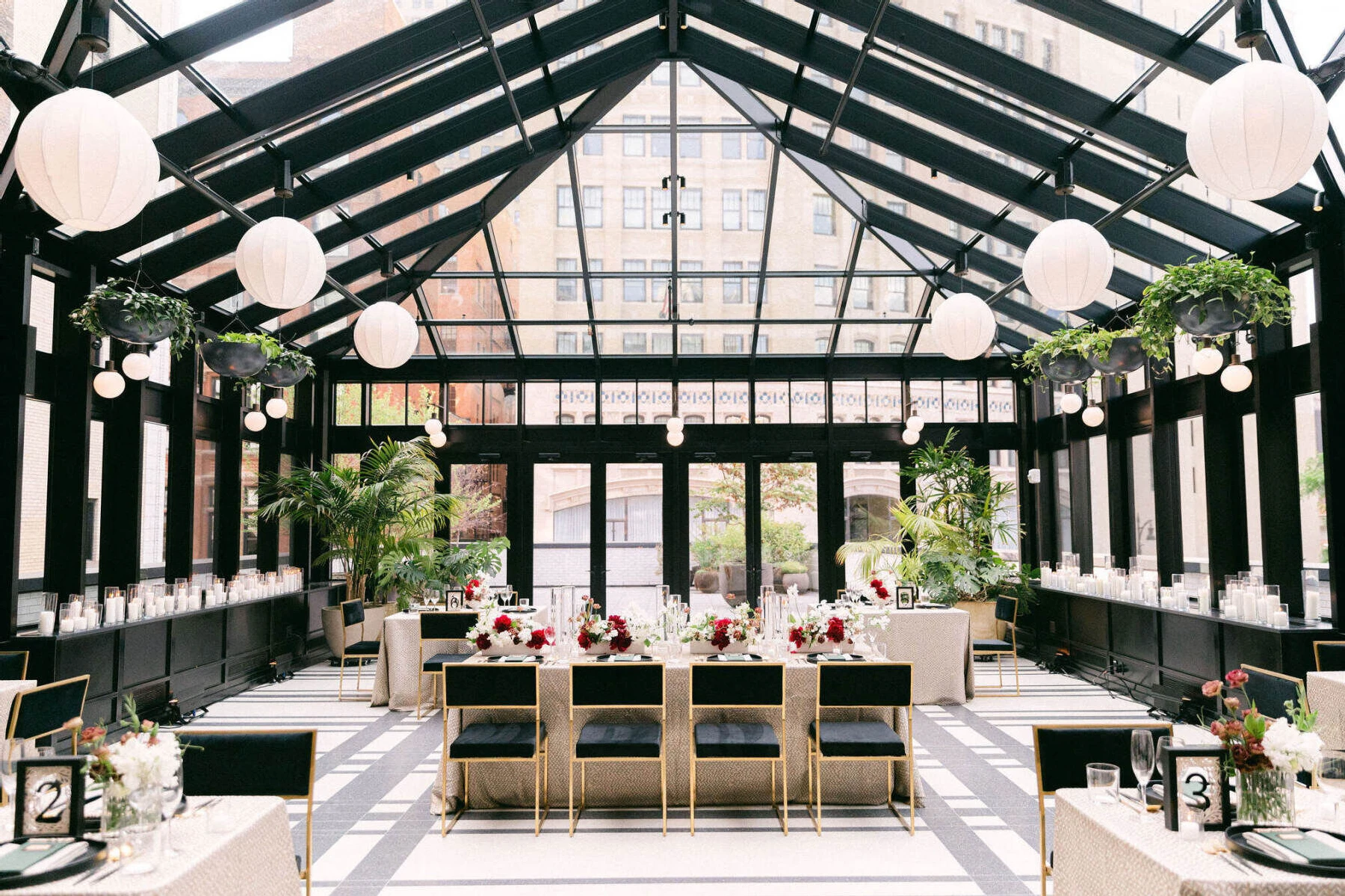 An industrial wedding venue got an elegant and modern treatment thanks to a mixture of specialty rental pieces and lots of candlelight.