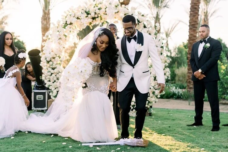 Jump the Broom: Wedding couple participating in the jumping the broom wedding tradition