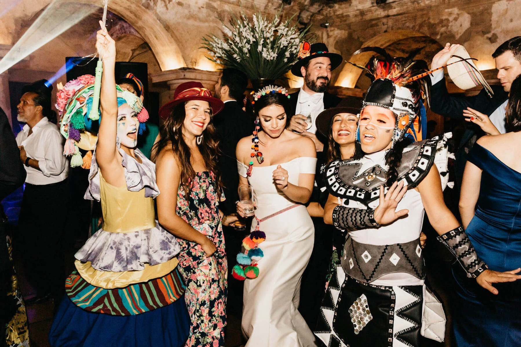 Latinx Heritage: A bride and groom dancing with professional entertainers at their wedding reception in Guatemala.