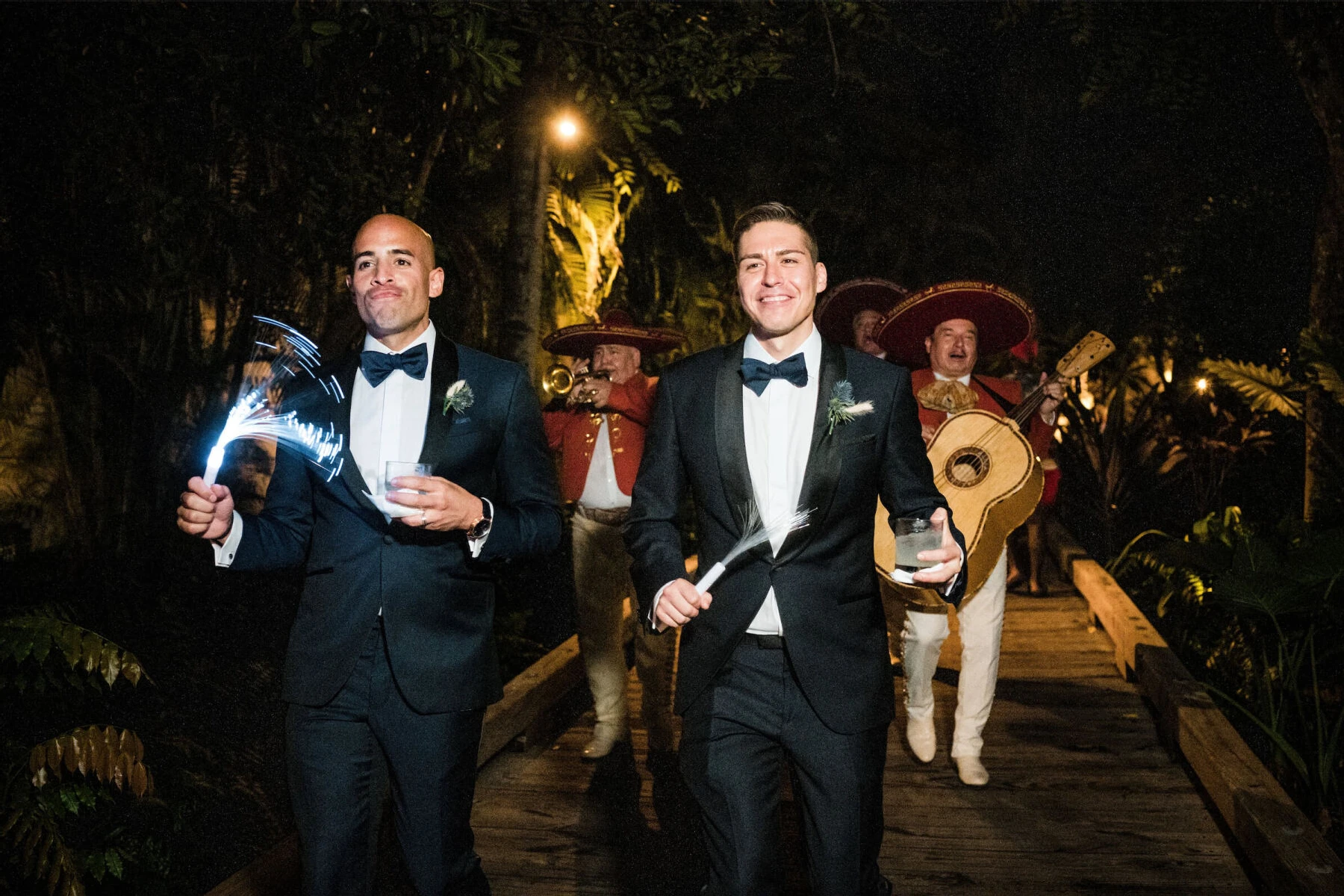 Latinx Heritage: Two grooms dancing with a mariachi band behind them at their wedding in Puerto Rico.