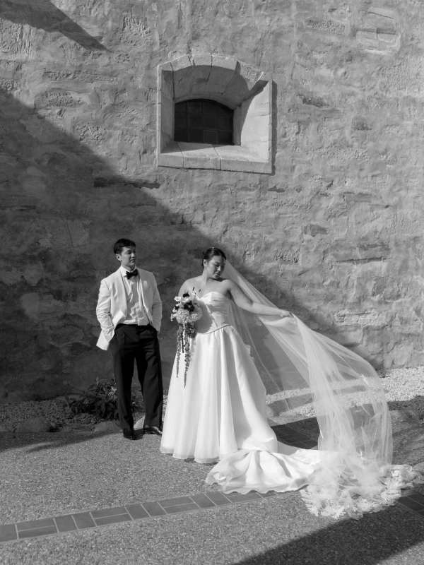 A Burgundy and Green Wedding Draped Between Old Plaster and Weathered Wood
