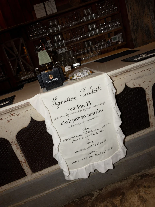 A Burgundy and Green Wedding Draped Between Old Plaster and Weathered Wood