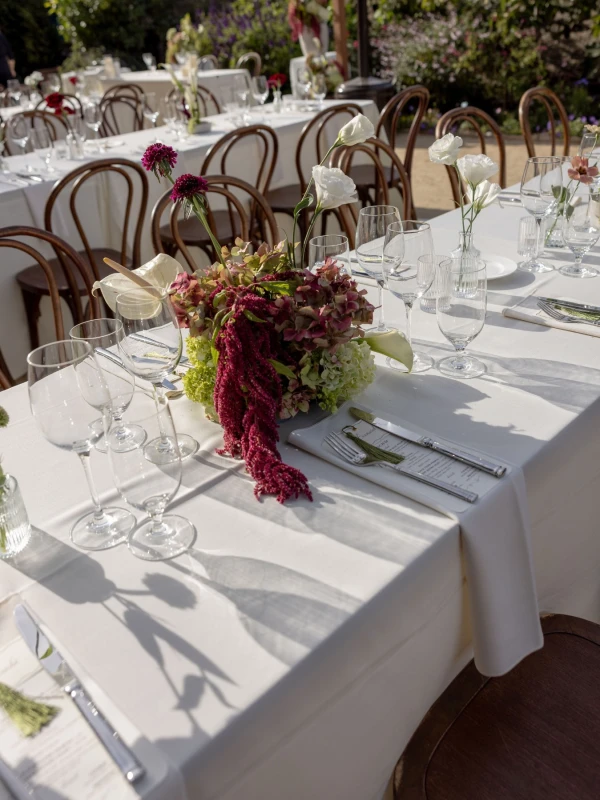 A Burgundy and Green Wedding Draped Between Old Plaster and Weathered Wood