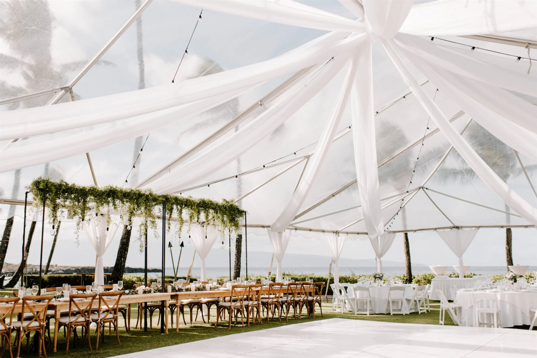 Marriott Weddings: Billowing white pieces of fabric converging at the top point of an outdoor reception tent in Hawaii.