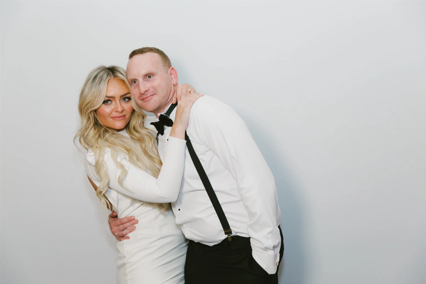 A bride and groom snap a pic in their photobooth at their modern California wedding.