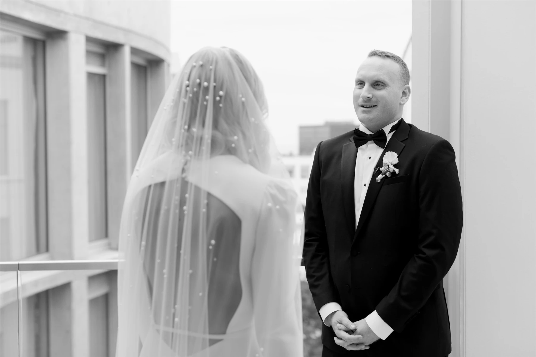 A bride and groom share an emotional first look before their modern California wedding ceremony.