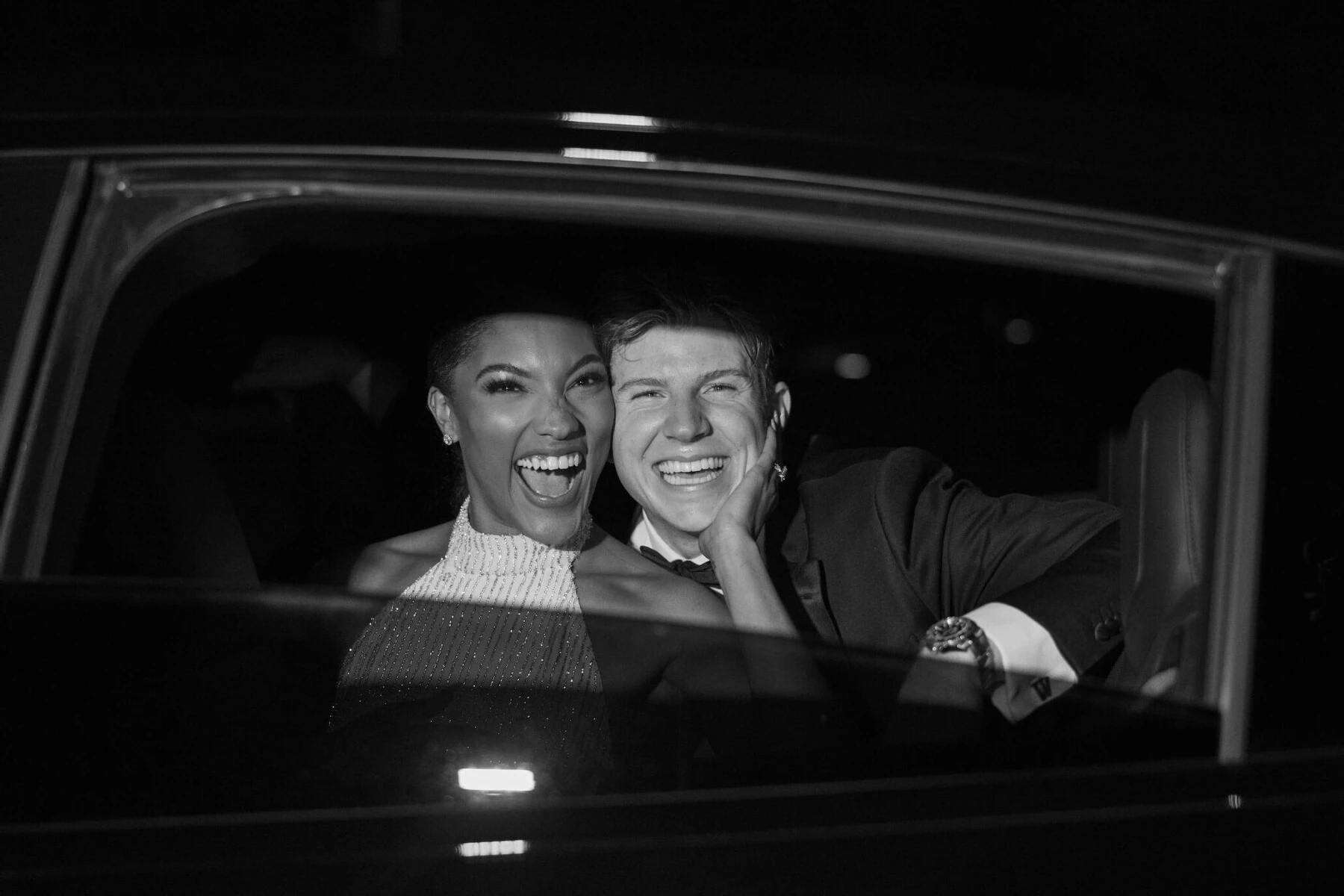 Newlyweds Tara Davis and Hunter Woodhall are all smiles from their getaway car at the end of their modern fairytale wedding.