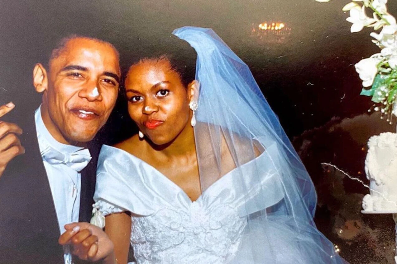 Most Influential Women in History Weddings: Michelle Obama posing with husband Barack Obama on their weddings day, post wedding cake cutting, both with frosting on their noses