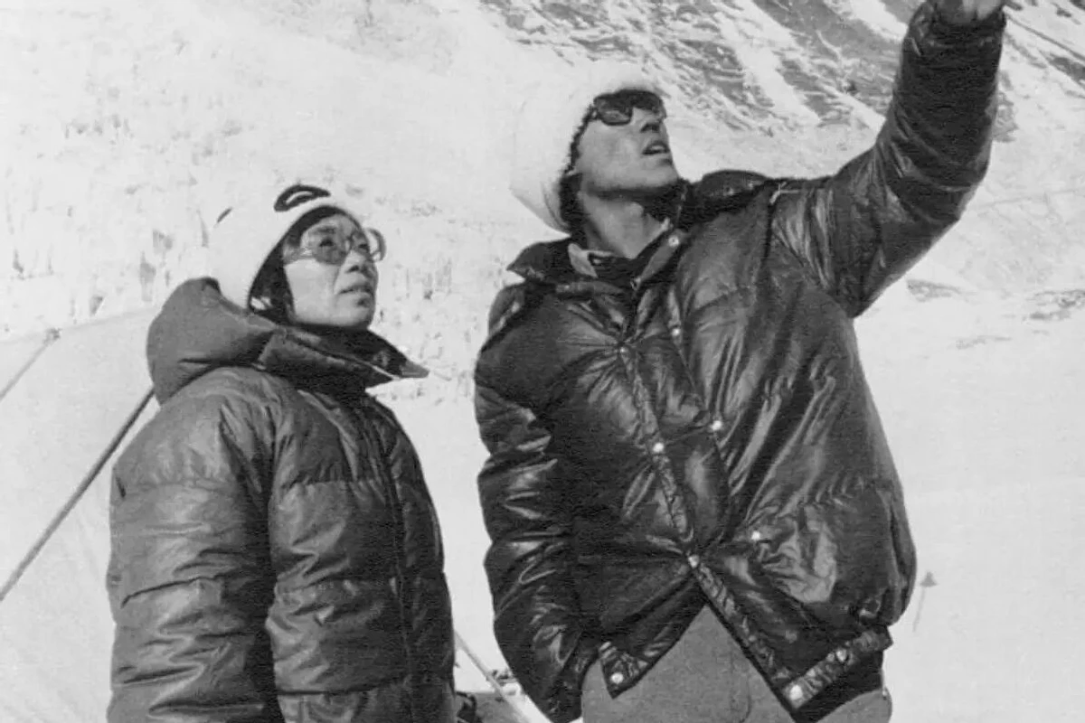 Most Influential Women in History Weddings: Junko Tabei standing with husband Masanobu Tabei at the base of a mountain assessing the accent 