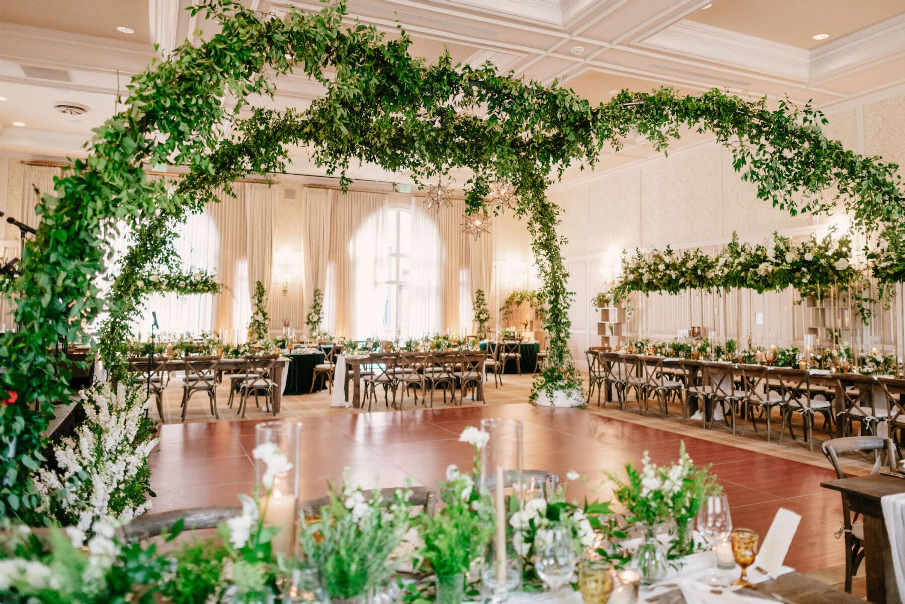 Mountain wedding details: The ballroom of Hotel Jerome, decorated with arches of greenery spanning the dance floor.