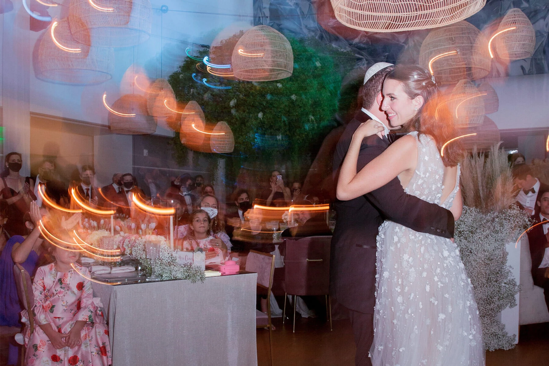 Wedding couple dancing at their museum wedding reception during dinner, with the band playing on the stage.