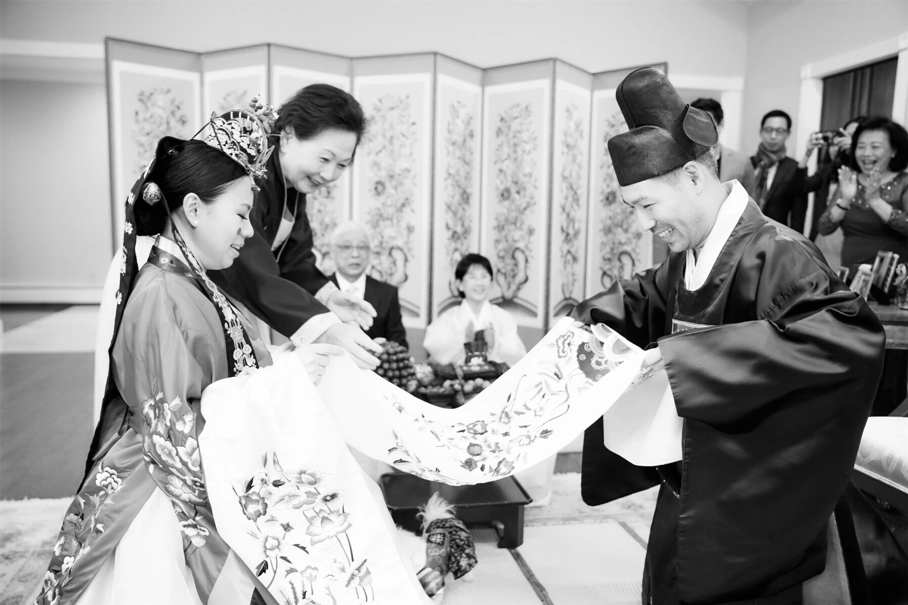 A couple during their Pyebaek ceremony at the groom's parents' home before celebrating at their restaurant wedding.