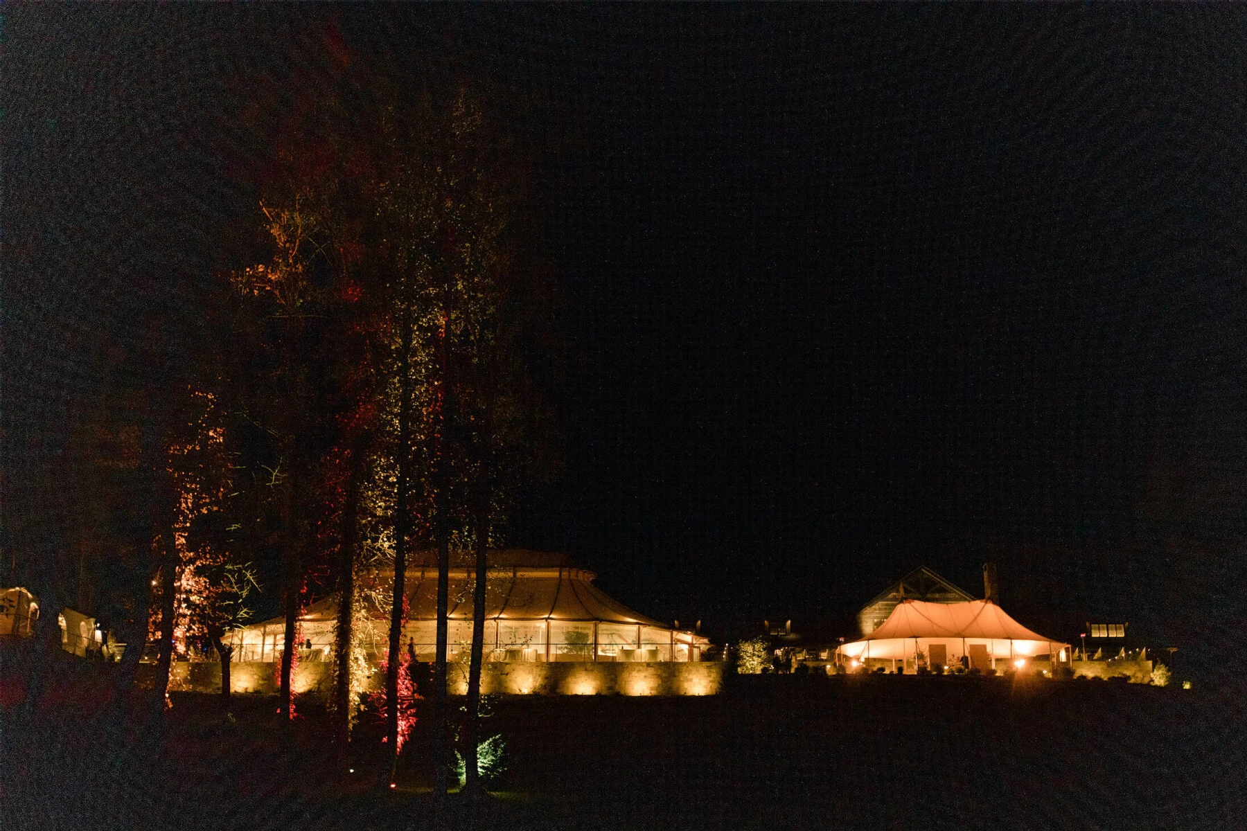 The tents glowed as the sun set during a wedding in Virginia.