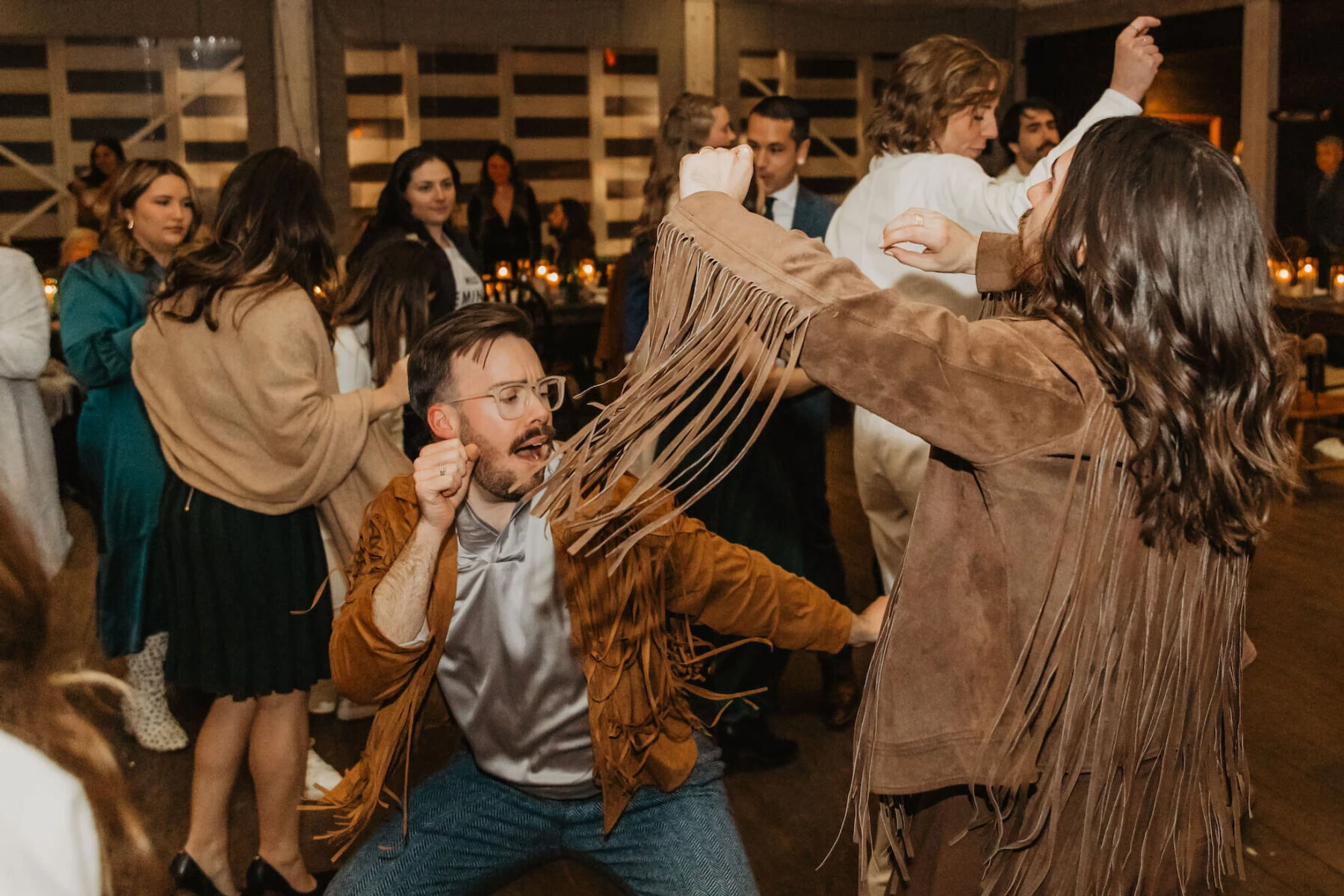 A couple and their wedding guests dance to music played by a DJ at this untraditional wedding near Austin, Texas.