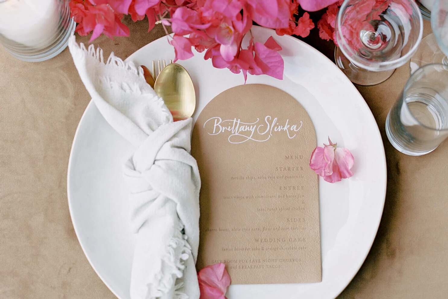 APink wedding details: A leather menu on a modern placesetting.