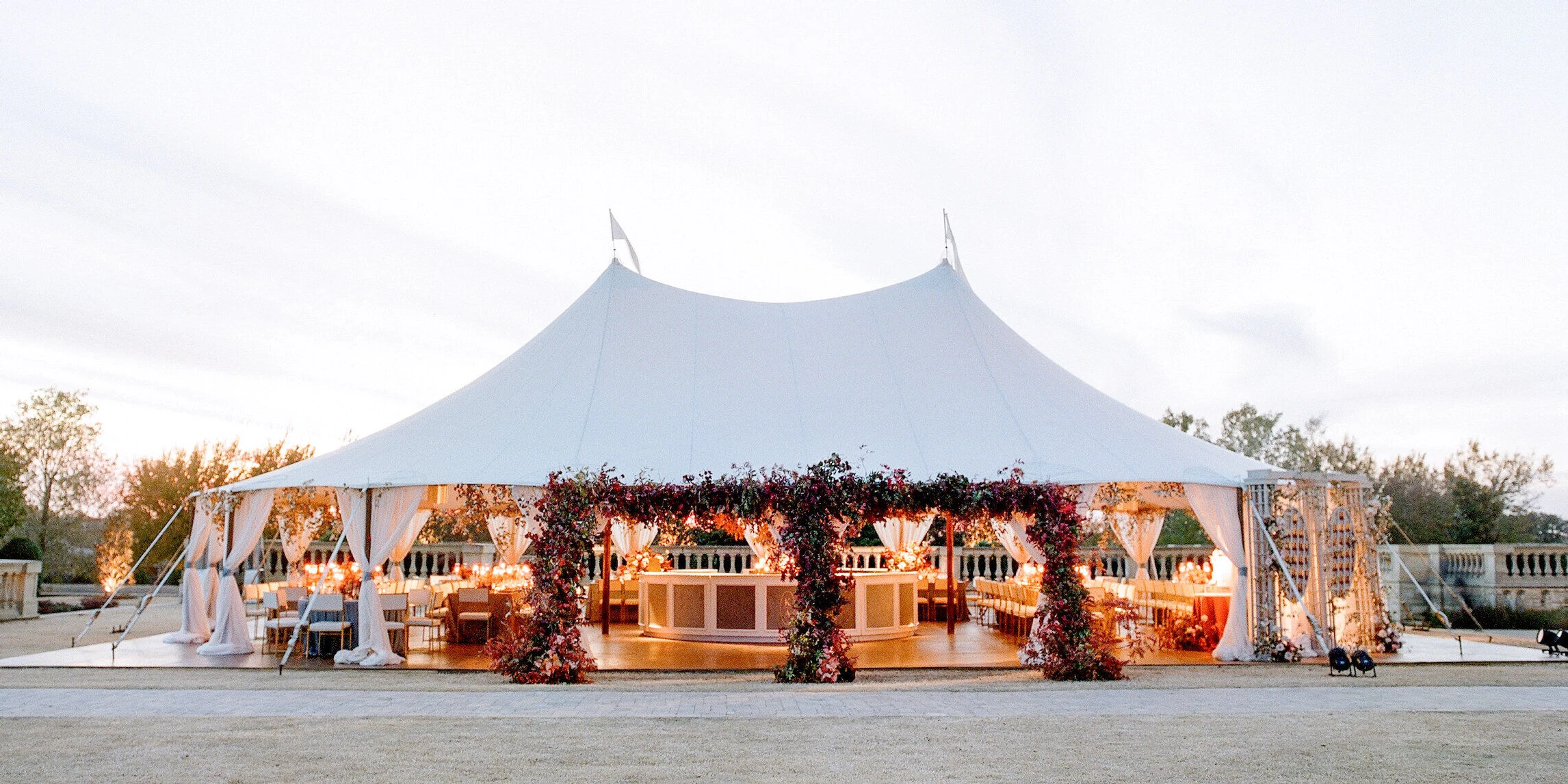 Wedding details: a glowing reception tent on a lawn in Texas