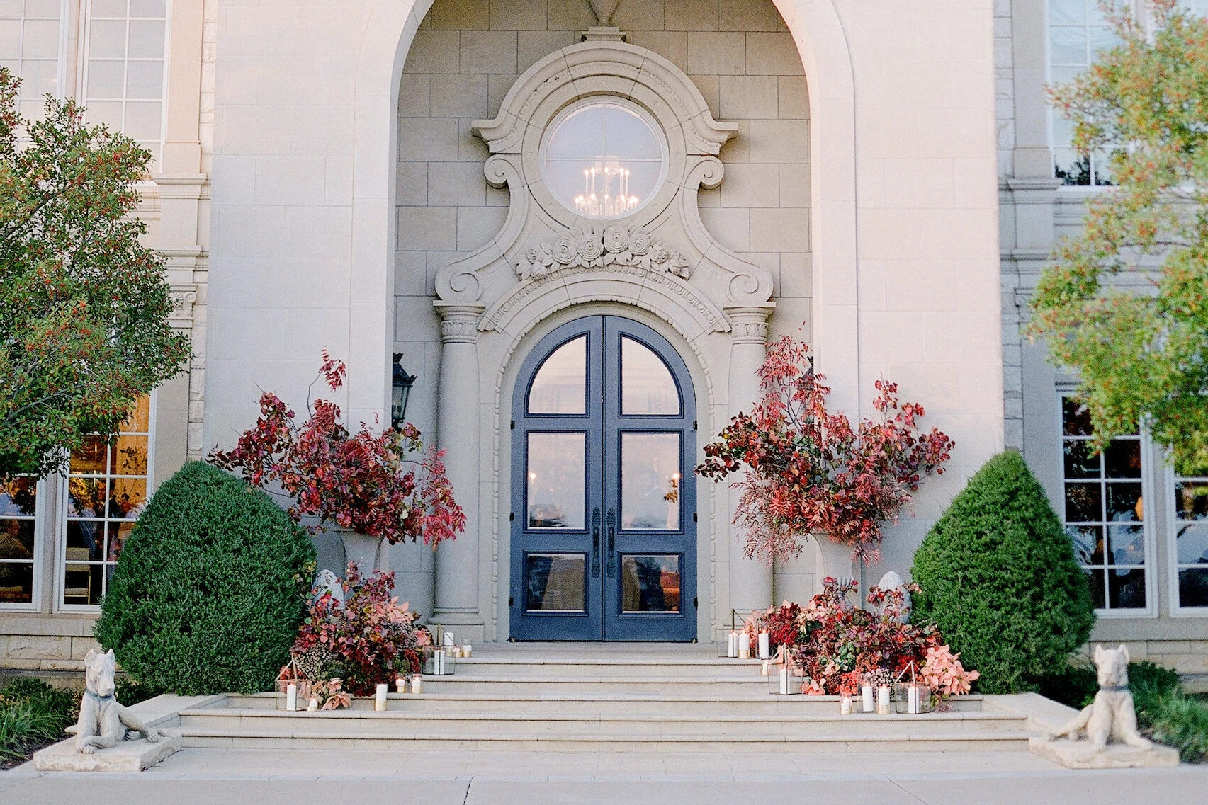 Wedding details: the facade of The Olana, decorated with flowers and candles