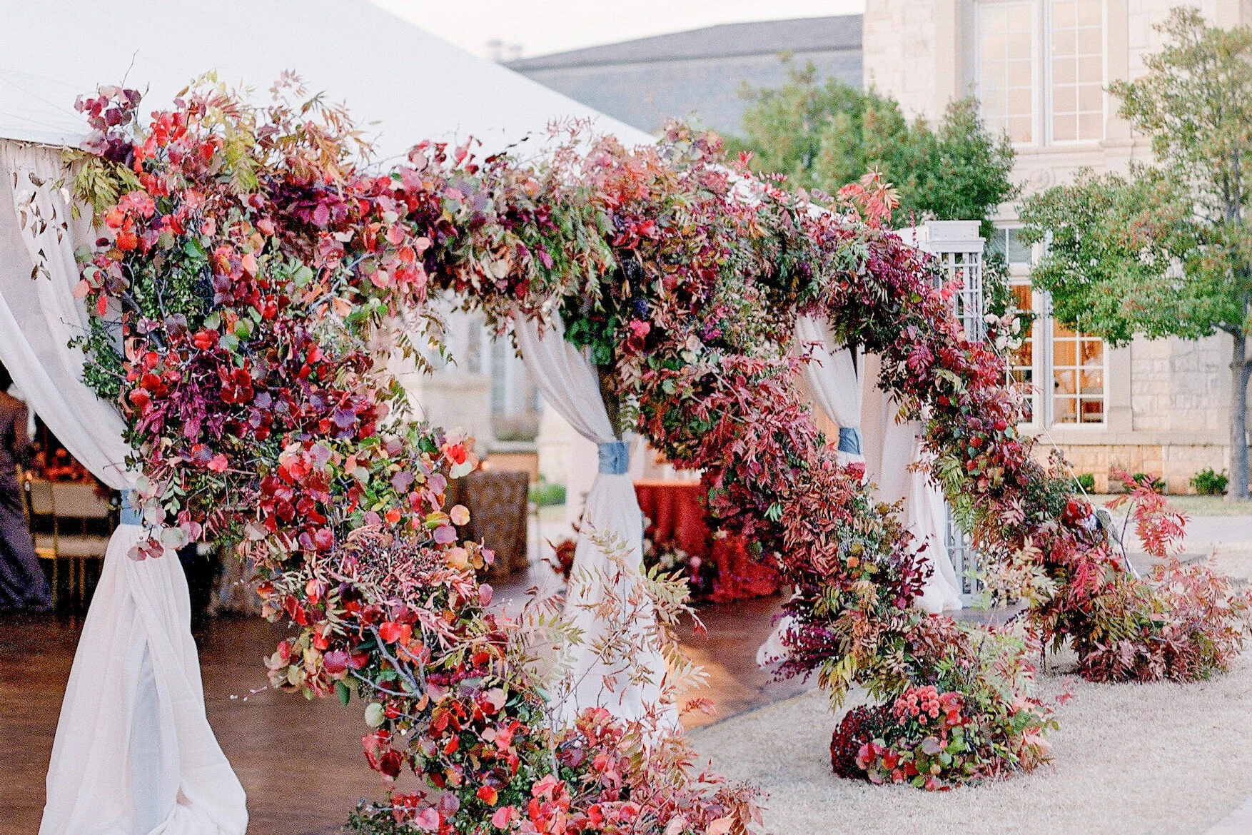 Wedding details: red and coral flowers at Kirby & Adam's tented wedding