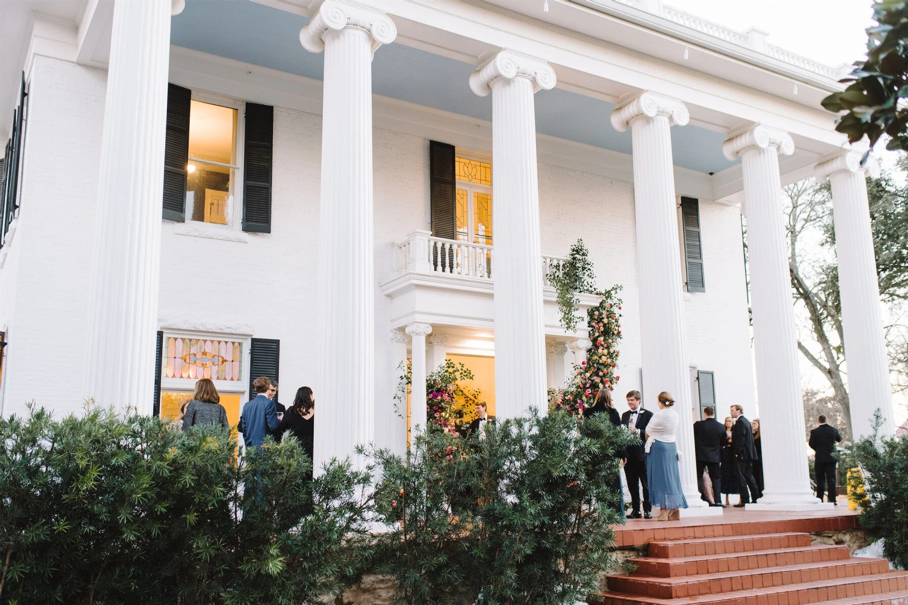 The columned facade of Woodbine Mansion, a wedding venue near Austin, Texas.