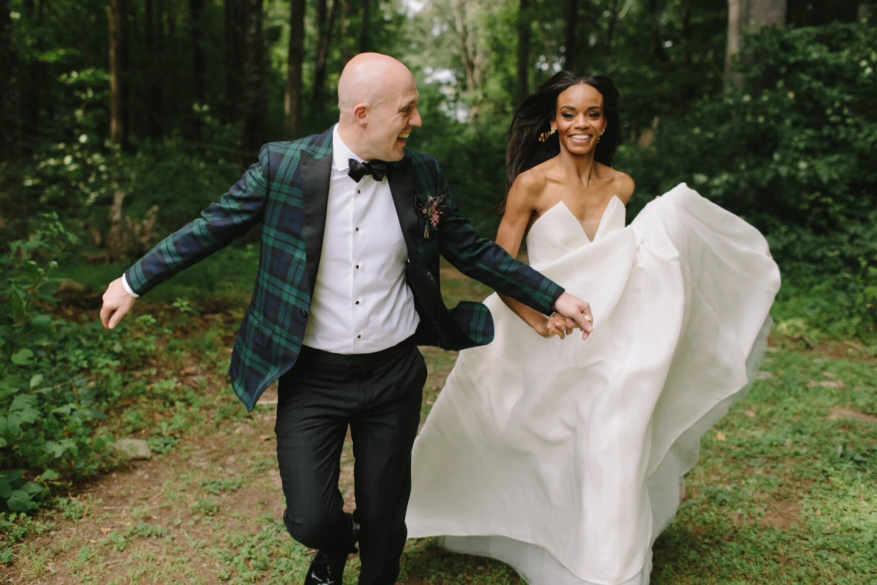 Wedding Dress Shopping: A bride and groom holding hands and running in a forest area.