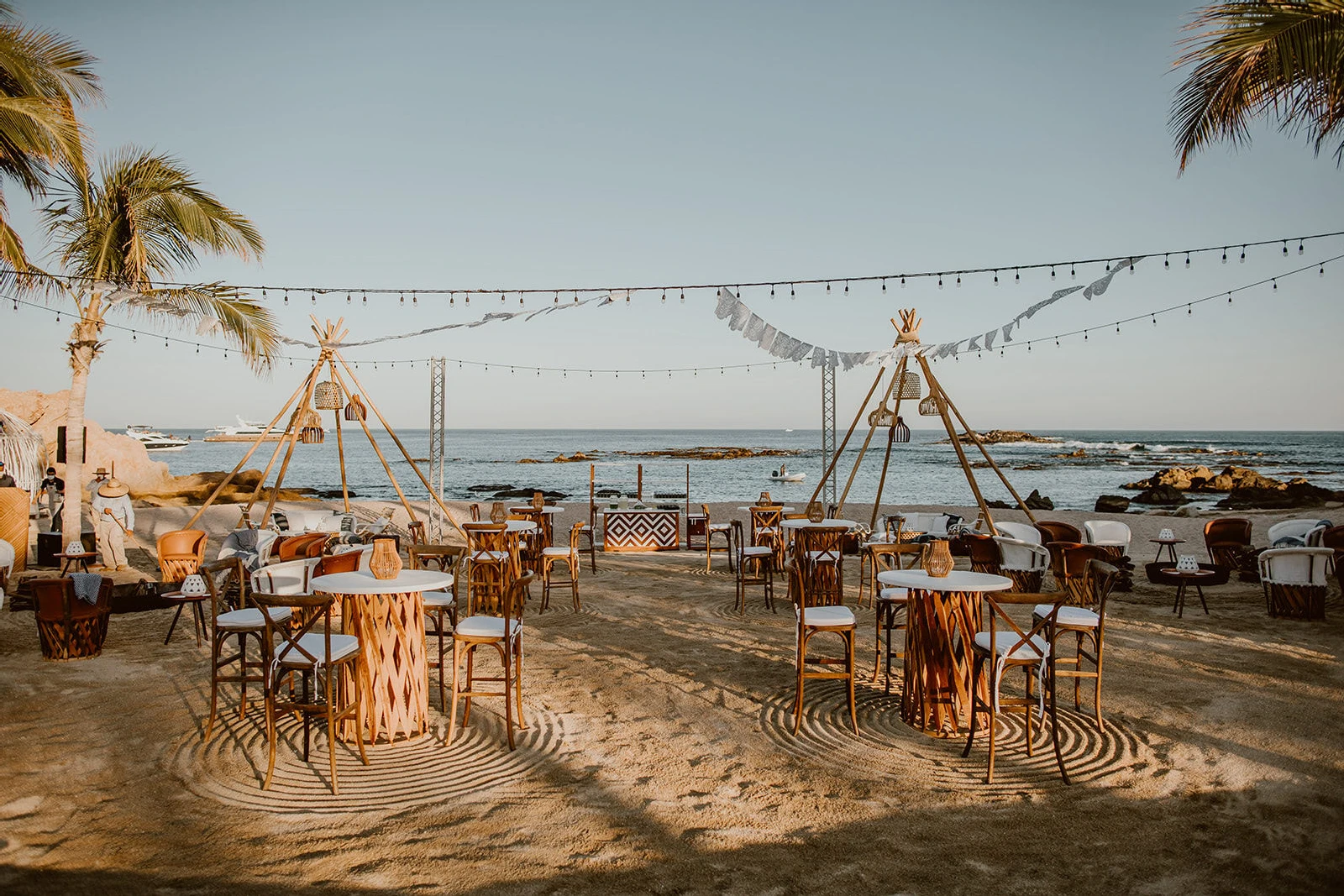 A Cabo wedding weekend began with a welcome fiesta on the beach, complete with papel picado flags overhead.